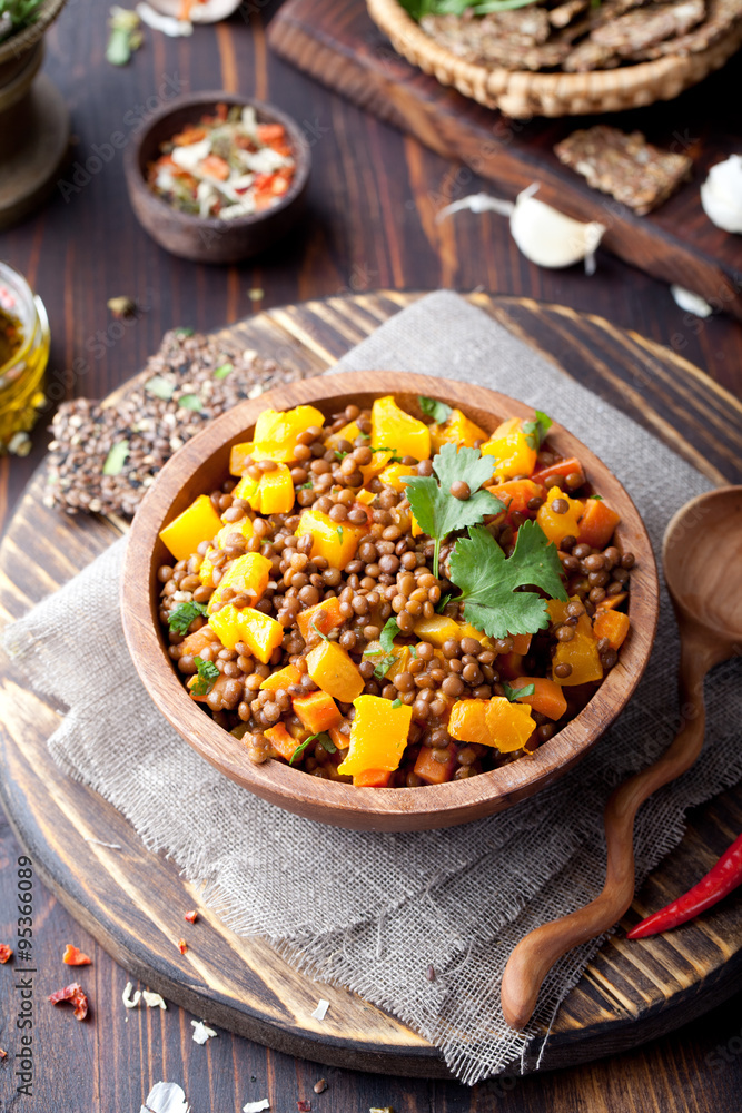 Lentil with carrot and pumpkin ragout in a wooden bowl. Lentil with carrot and pumpkin ragout in a wooden bowl.
