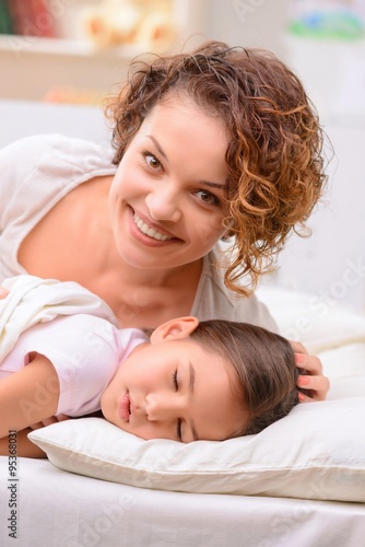 Delighted mother and daughter sleeping  