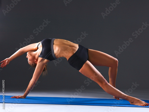 Portrait of sport girl doing yoga stretching exercise