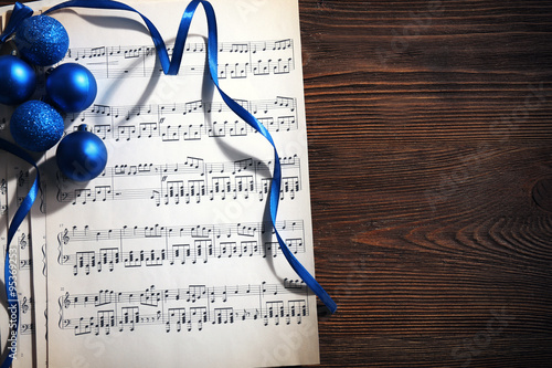 Music and Christmas decor on wooden table photo