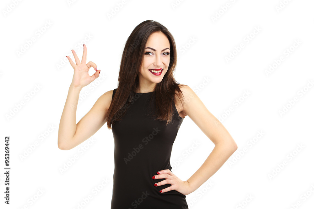 Young brunette woman in black dress on a white background Young brunette woman in black dress on a white background