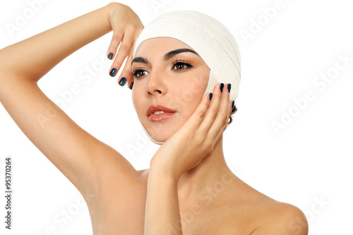 Young beautiful woman with an elastic bandage on her head, isolated on white