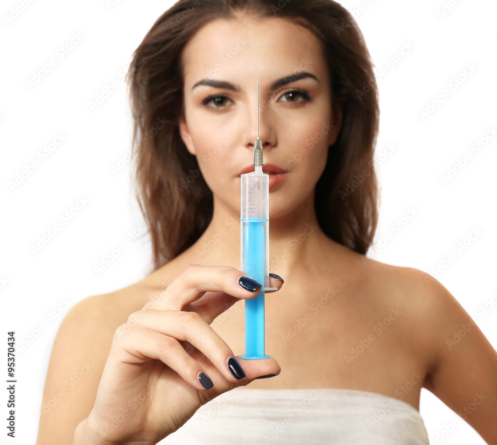 Young beautiful woman with a bandage on her chest, holding syringe, on grey background Young beautiful woman with a bandage on her chest, holding syringe, on grey background