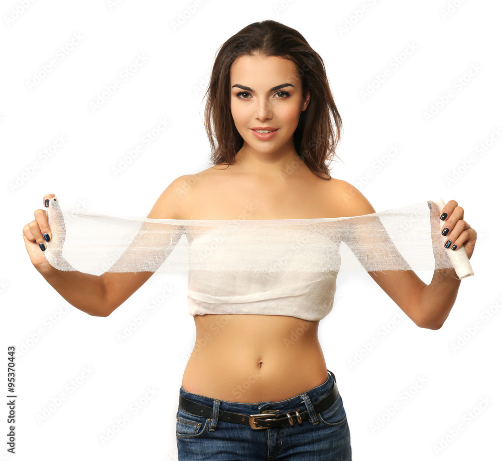 Young beautiful woman with a bandage on her chest, holding gauze, isolated on white Young beautiful woman with a bandage on her chest, holding gauze, isolated on white