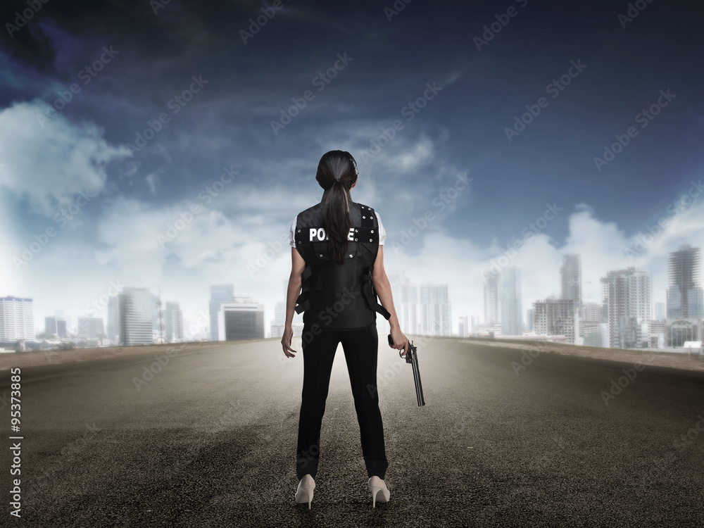 Fototapeta premium Police woman standing on the empty street