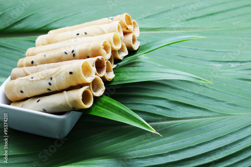 crispy roll snack on green leaves photo