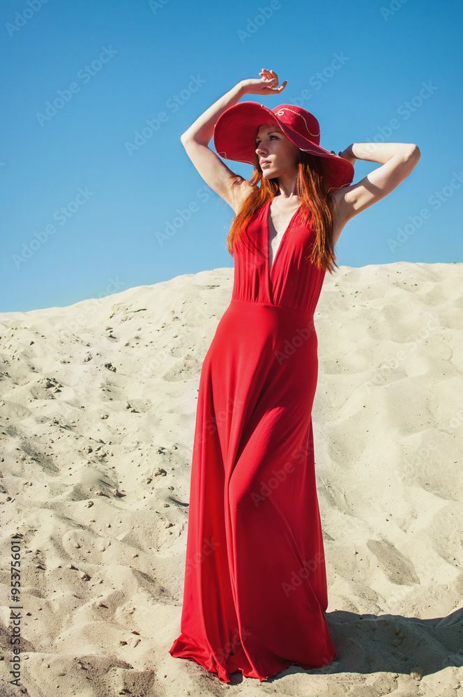 Beautiful Woman in Red Dress on the Beach