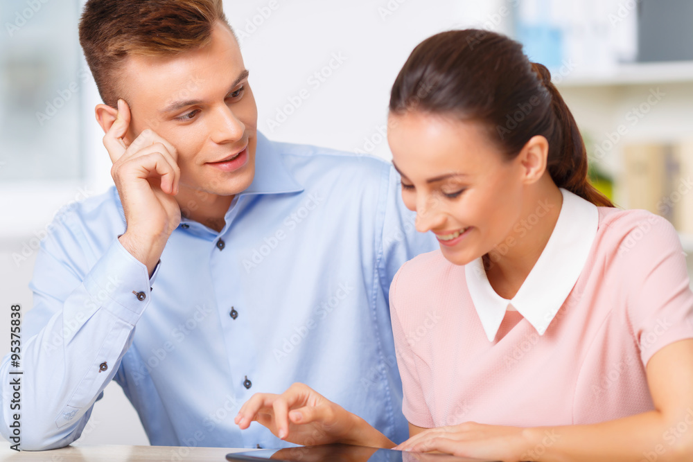 Young manager watches his sweetheart at work. Young manager watches his sweetheart at work.