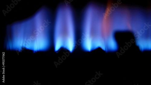 Blue flames of a gas burner inside of a boiler
