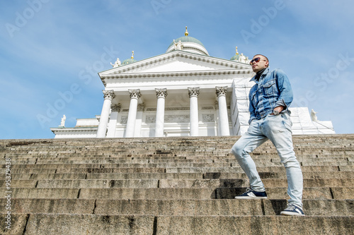 man stands on the granite stairs at the Cathedral on the Senate