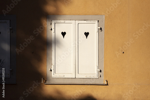 White wooden window with heart symbols