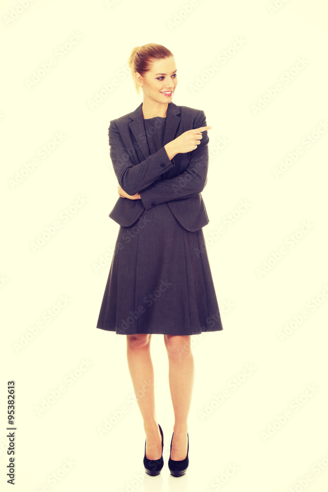 Beautiful businesswoman pointing aside. Beautiful businesswoman pointing aside.