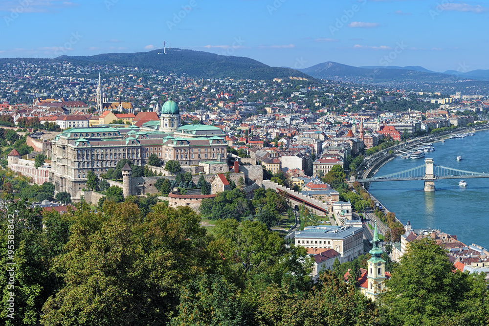 Buda Castle with Royal Palace and Matthias Church and fragment of the Szechenyi Chain Bridge over Danube in Budapest, Hungary. View from the Gellert Hill.