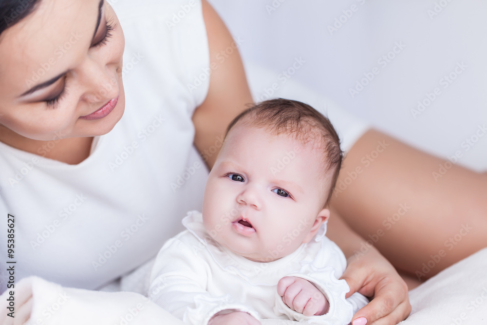 Young happy beautiful mother with her little baby