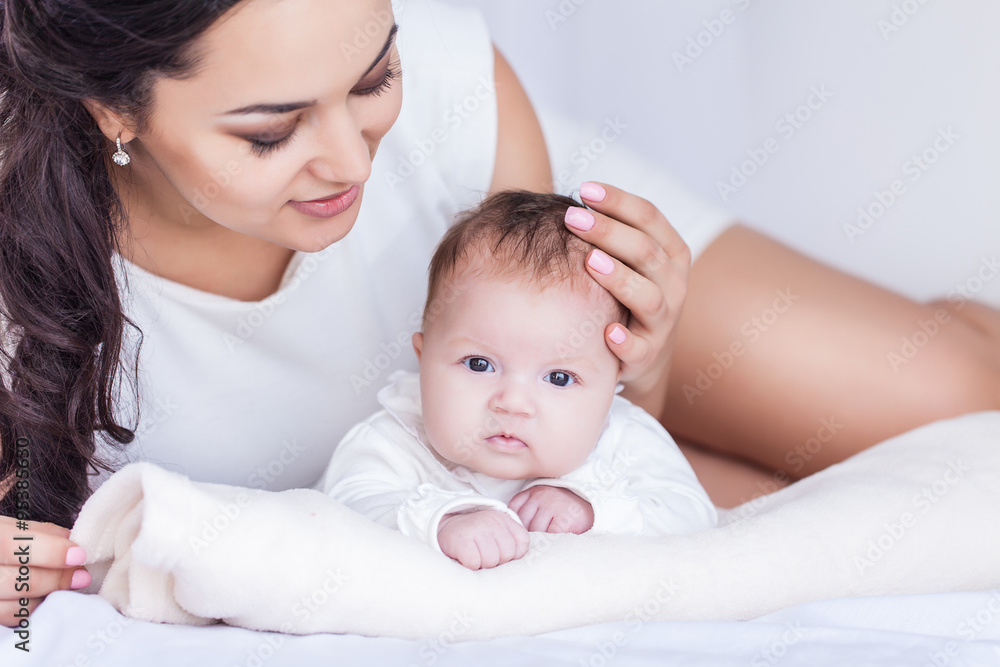 Young happy beautiful mother with her little baby Young happy beautiful mother with her little baby
