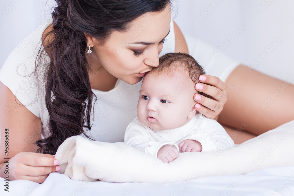 Young happy beautiful mother with her little baby Young happy beautiful mother with her little baby