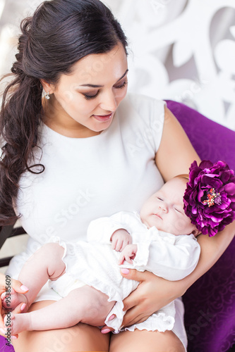 Young happy beautiful mother with her little baby