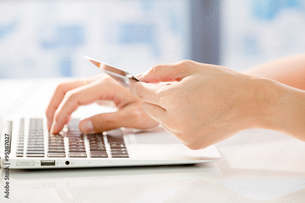 Woman Hands holding credit card and using laptop. Online shoppin Woman Hands holding credit card and using laptop. Online shoppin