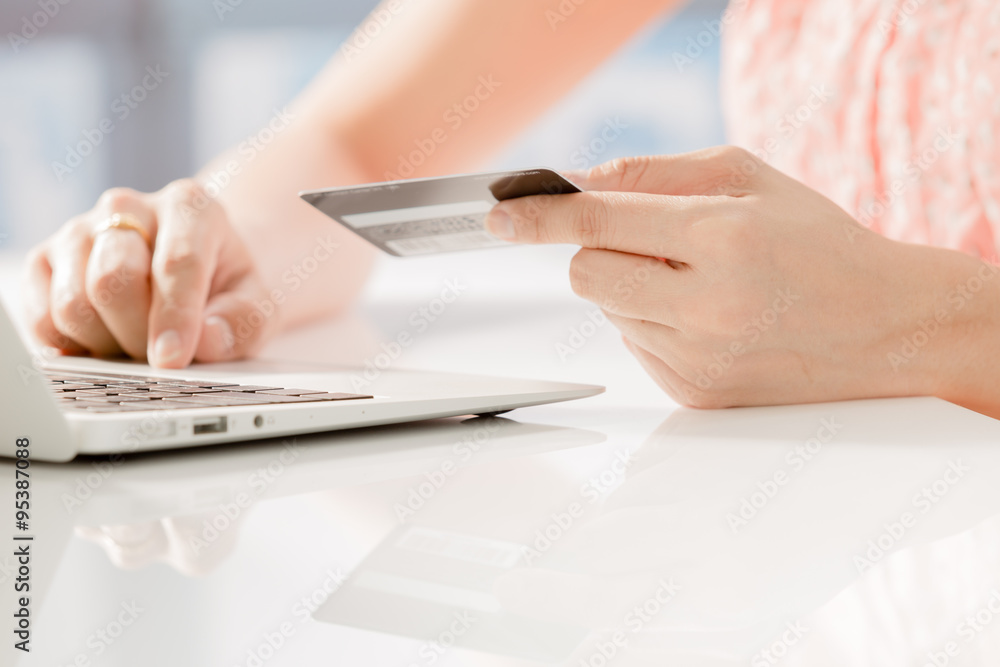 Fototapeta premium Woman Hands holding credit card and using laptop. Online shoppin