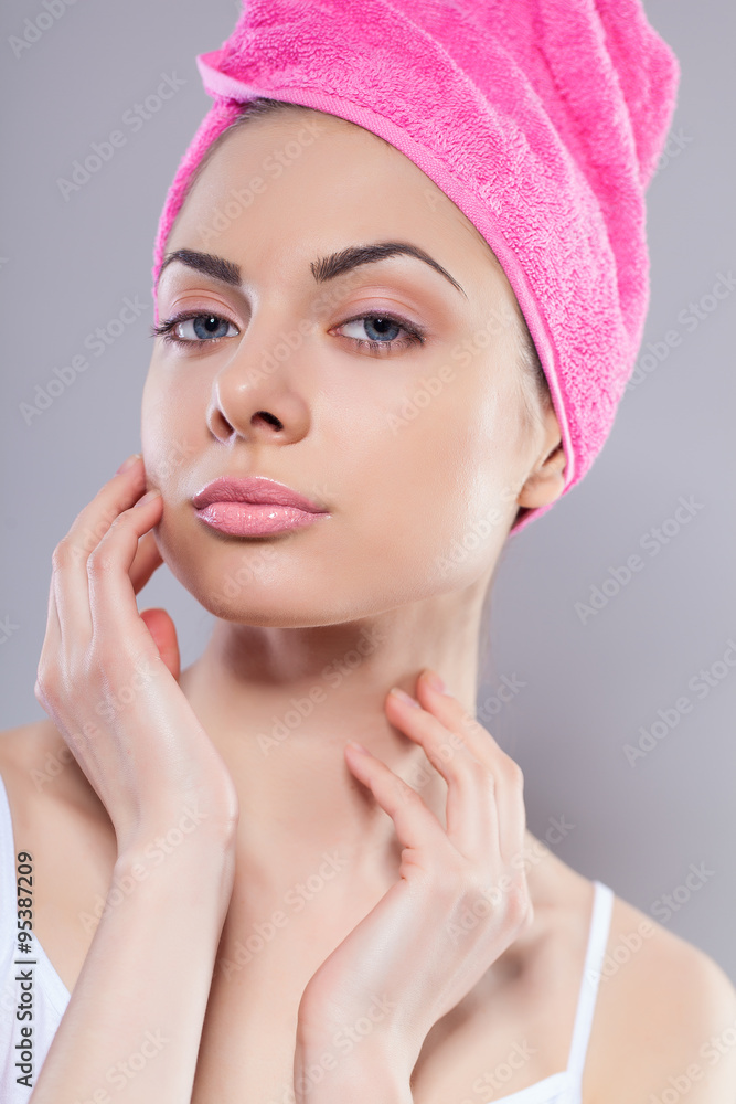 Portrait of young woman with perfect health skin of face and bath towel on head Portrait of young woman with perfect health skin of face and bath towel on head
