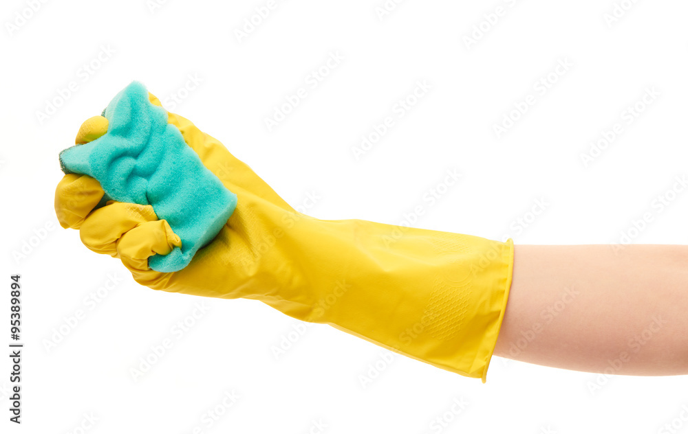 Close up of female hand in yellow protective rubber glove holding green cleaning sponge against white background Close up of female hand in yellow protective rubber glove holding green cleaning sponge against white background