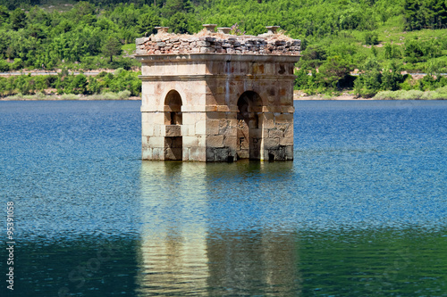 destruction of old bell tower of submerged village Muedra  forma photo