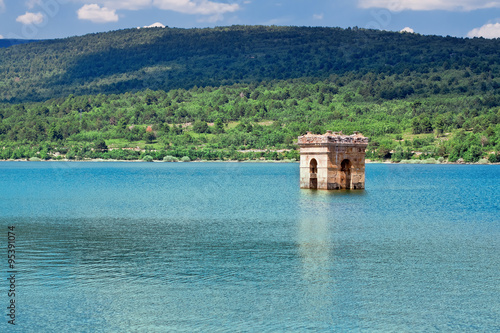 destruction of old bell tower of submerged village Muedra  forma photo