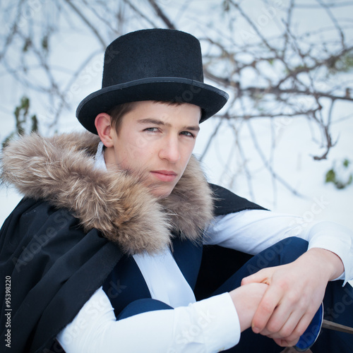 Handsome  elegantyoung man with rapier, outdoor photo