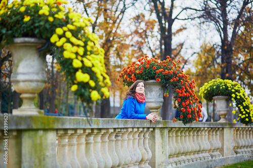Beautiful tourist in Parisian park on a fall day