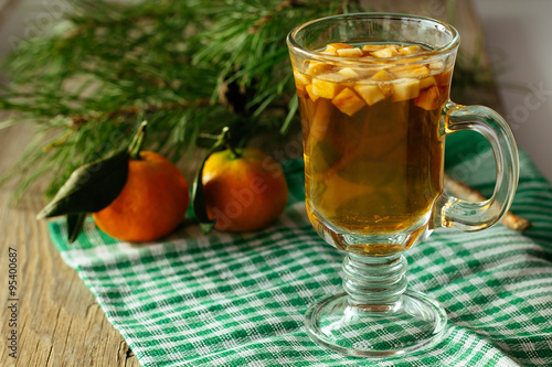 Glass of christmas punch and tangerine