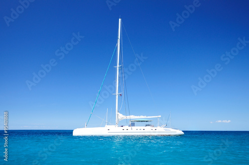 Tela Sailing catamaran in the blue carribean sea