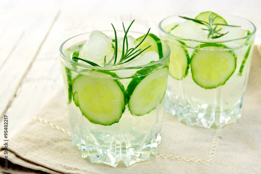 Lemonade with cucumber and rosemary in two glassful on napkin Lemonade with cucumber and rosemary in two glassful on napkin