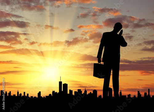  Silhouette of businessman talking on the phone
