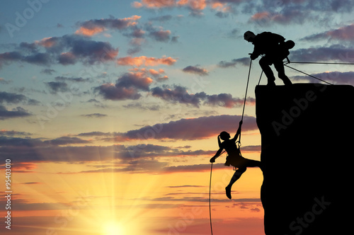 Silhouette of two climbers