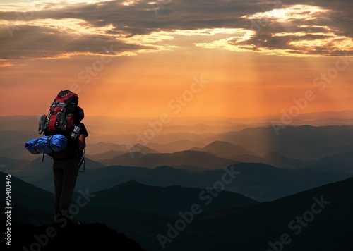 view of man on mountains with big rucksack on back