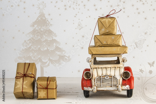Christmas holiday concept with gift boxes on toy car
