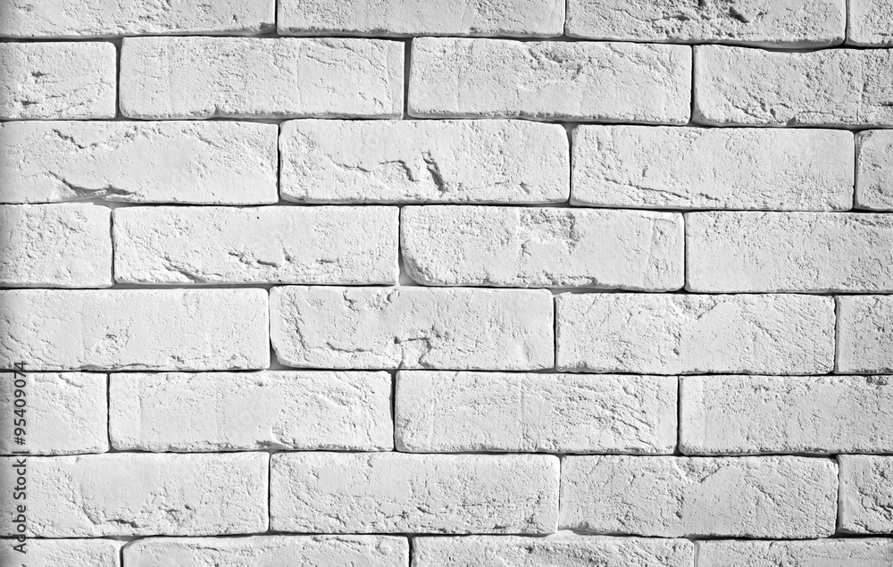 Obraz premium Brick wall texture in white painted masonry features clean horizontal rows, subtle mortar shadows, and a rustic loft surface finish for modern interior design background projects