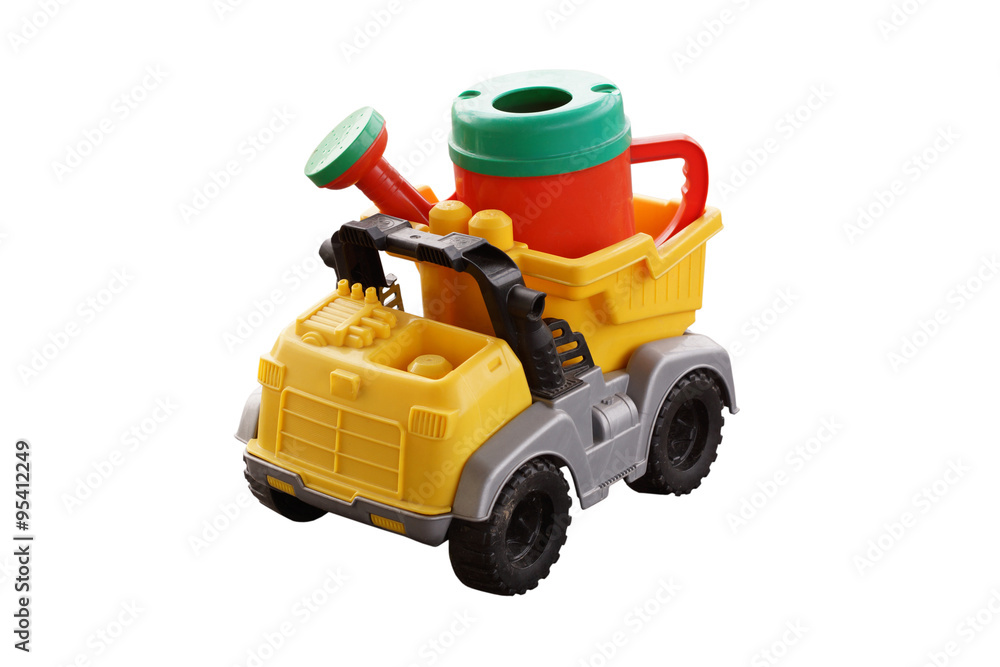 Plastic watering can in the back of a toy car. Plastic watering can in the back of a toy car.