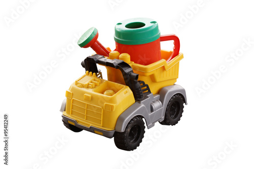 Plastic watering can in the back of a toy car.
