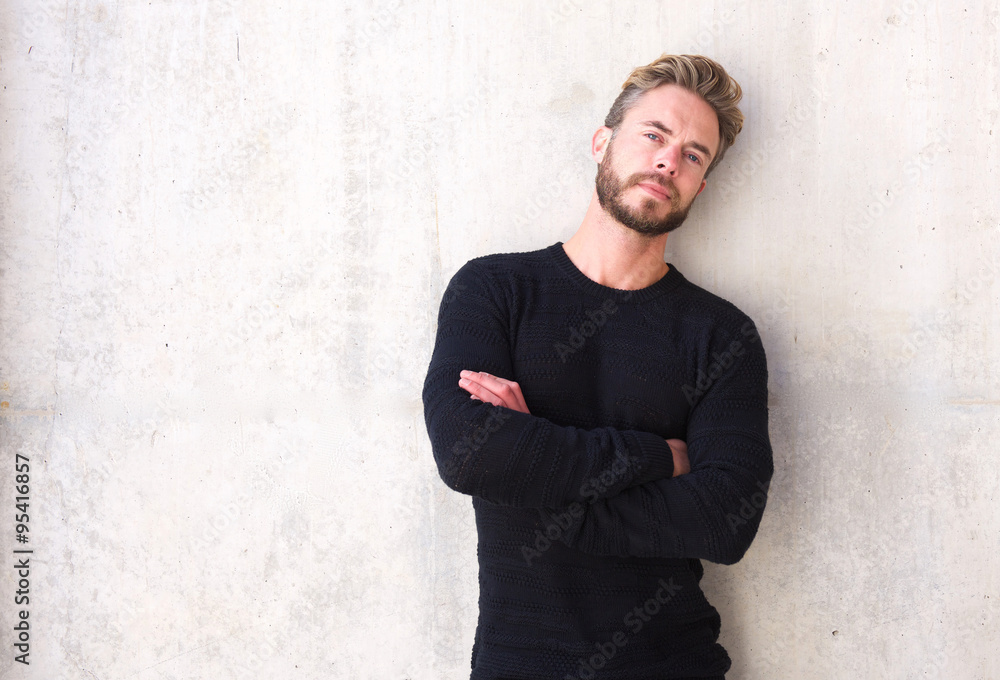 Male fashion model with beard posing with arms crossed - obrazy, fototapety, plakaty 
