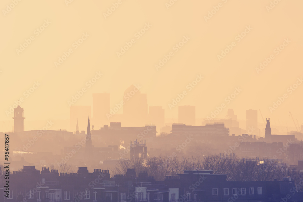 London Cityscape at Sunrise with early morning mist from Hampstead Heath looking towards Canary Wharf, England, UK