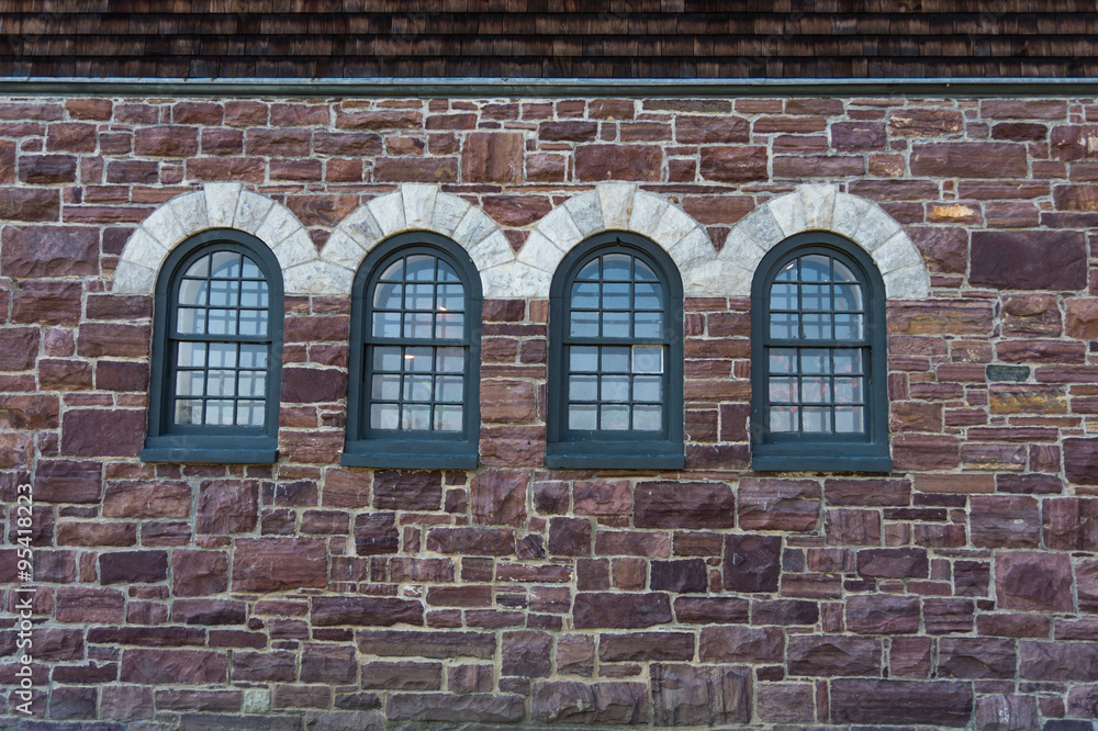 arched windows on the stone wall of a historic Farm Barn at Shelburne Farms, National Historic Site

