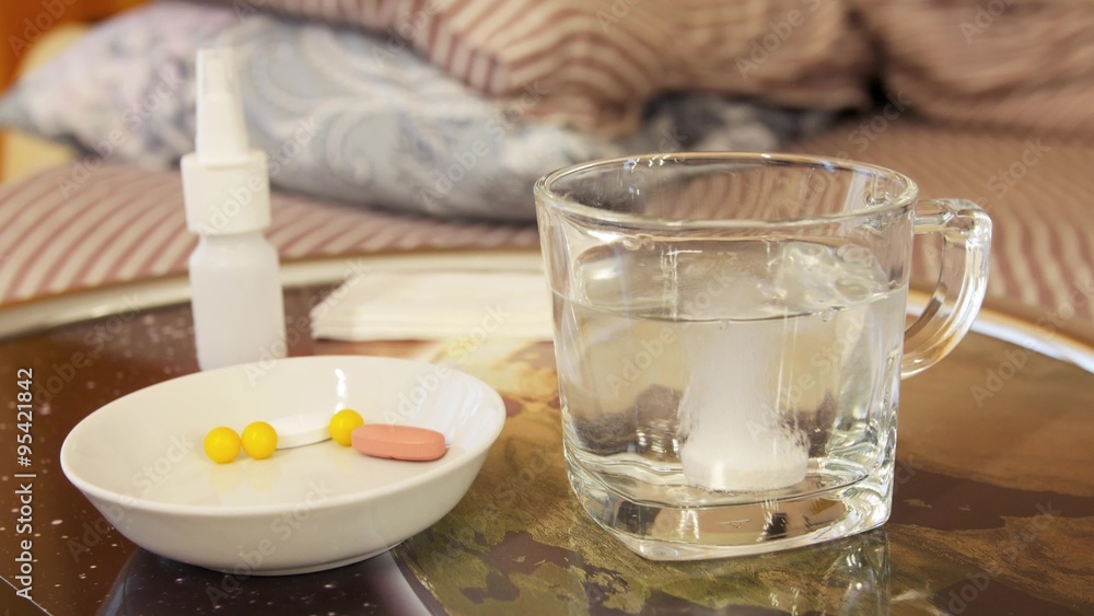 Soluble white tablet dissolves in glass with water Soluble white tablet dissolves in glass with water