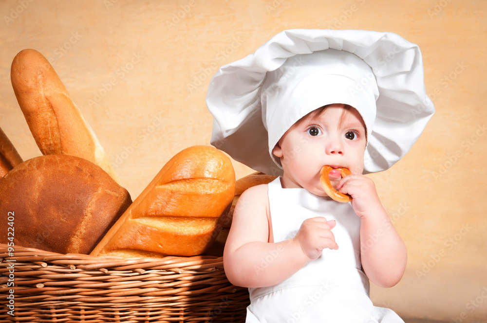 Little cook with a bagel in her hands. Little cook with a bagel in her hands.