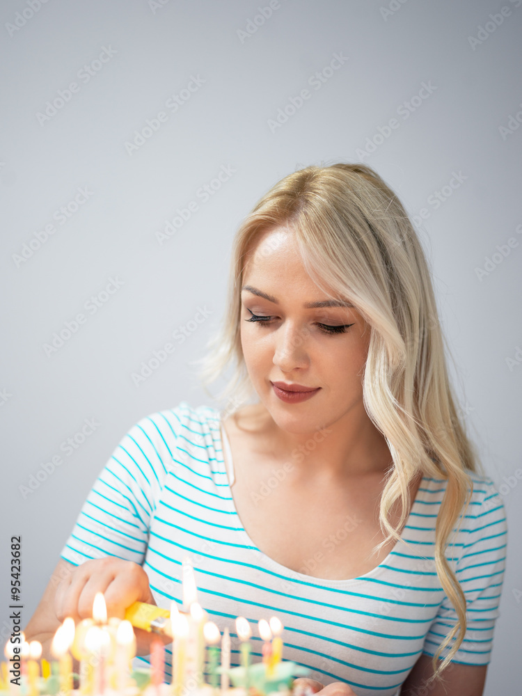 Portrait of a young beautiful blond girl holding plate with birt Portrait of a young beautiful blond girl holding plate with birt