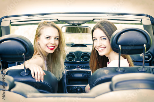 Two girls in cabriolet, out...
