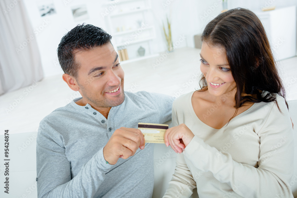 Couple both holding credit card Couple both holding credit card