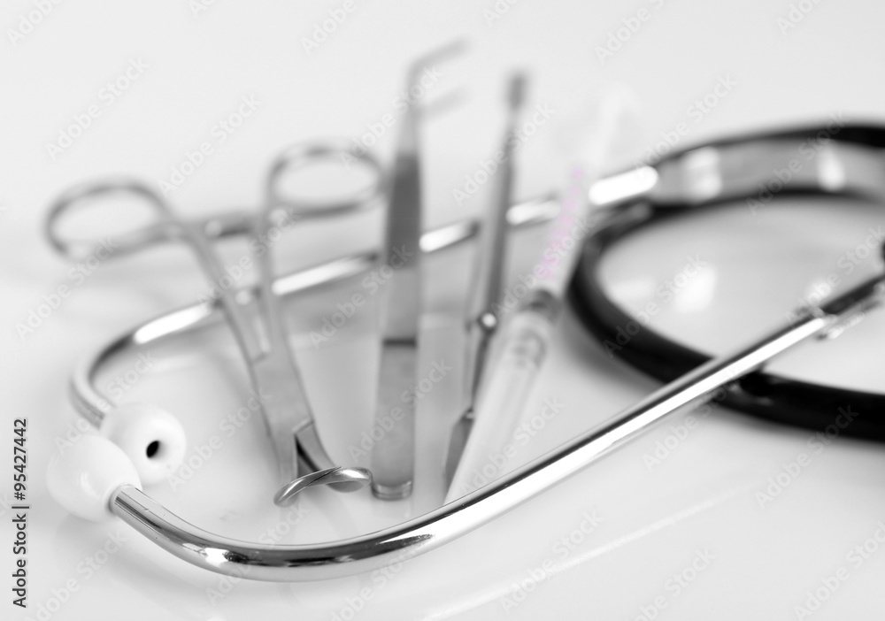 Stethoscope and medical instruments on white background, close up Stethoscope and medical instruments on white background, close up