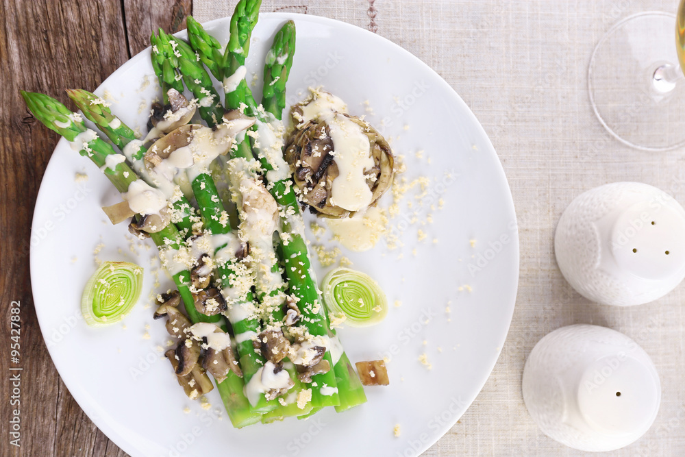 Appetizing dish with asparagus and mushrooms on served table in the restaurant Appetizing dish with asparagus and mushrooms on served table in the restaurant