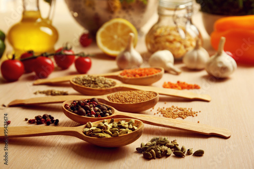 Variety of spices in spoons on the kitchen table